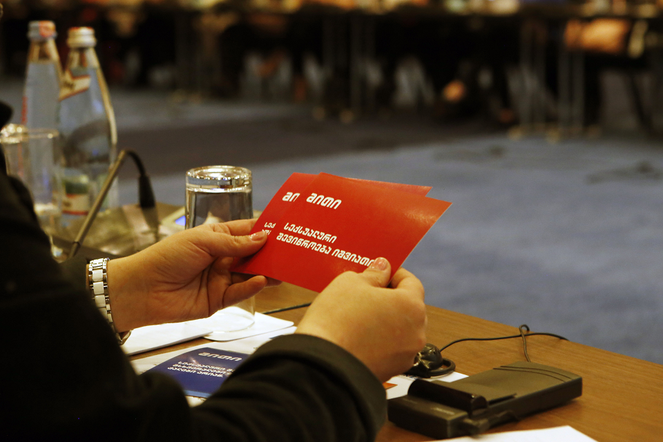 The woman is getting acquainted with the communications materials on sexual harassment. Photo: UN Women/Maka Gogaladze