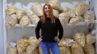 Nona Noniashvili proudly stands in the storeroom of the apple chips company, Enkeni. Photo: UN Women/ Tara Milutis